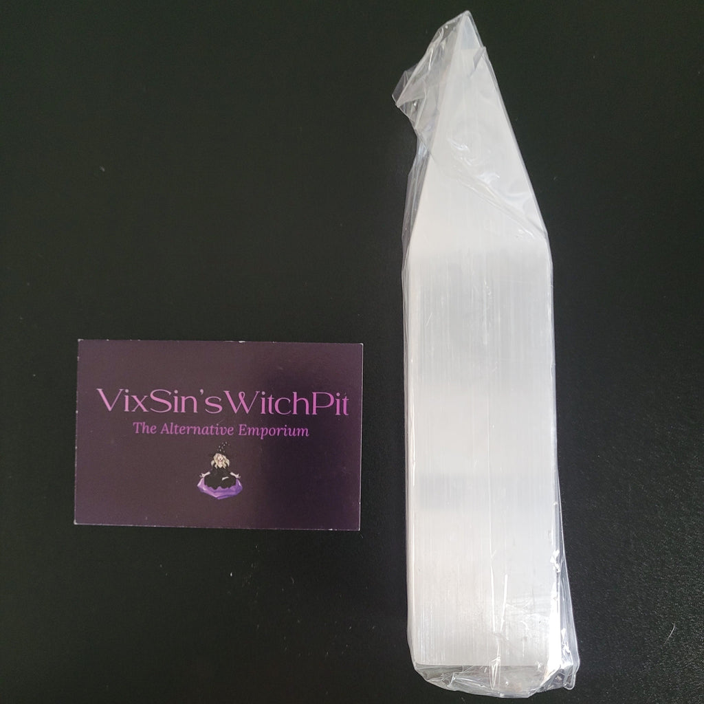 Clear Selenite Crystal Obelisk on a black background with a purple card displaying 'Vixsin's WitchPit'.