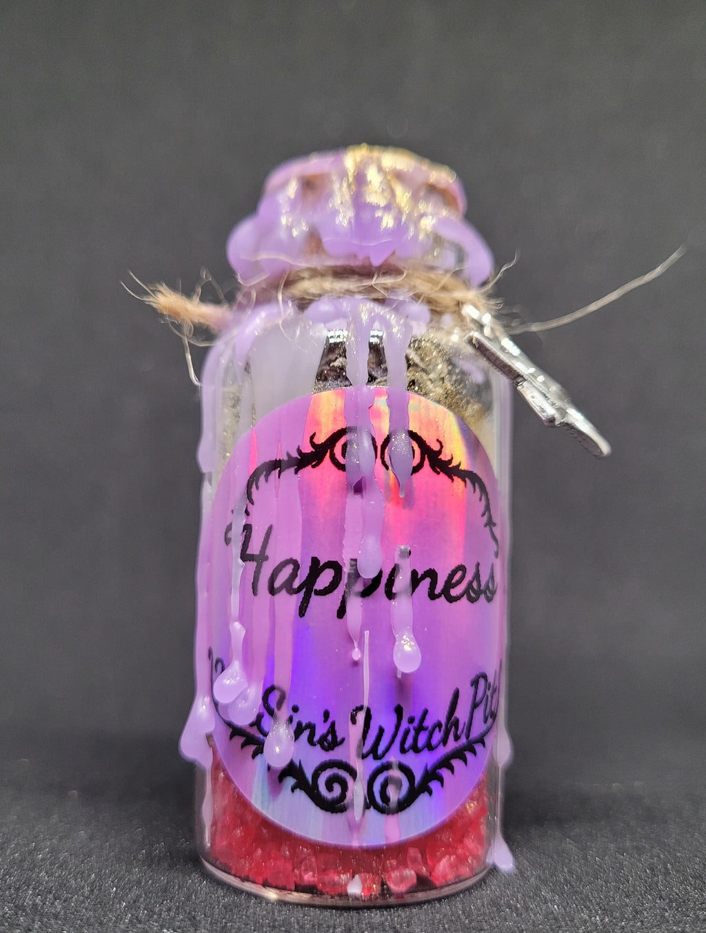 Decorative Spell-bottle with purple VixSin's WitchPit branding and 'Happiness' text.